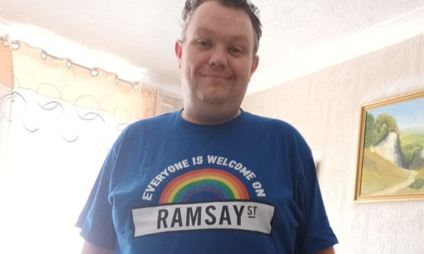 Calvin wearing his Everyone Is Welcome on Ramsay St T-shirt