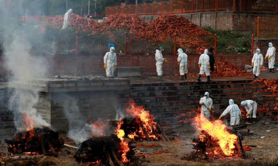 Workers wearing personal protective equipment enlarge a crematorium in Kathmandu, Nepal