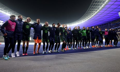 Wolfsburg players celebrate towards their fans after the 5-0 victory at Hertha Berlin.