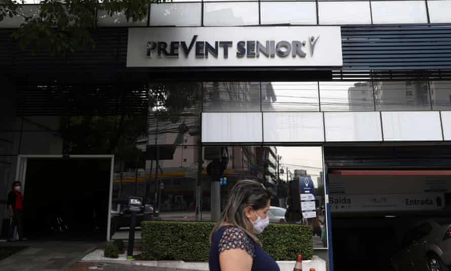 A woman passes by the entrance of a Prevent Senior hospital in São Paulo on 28 September.