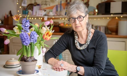 Gaie Dela sitting next to a pot of flowers