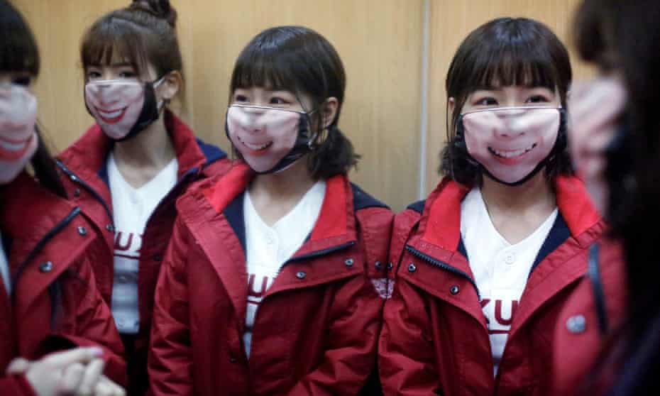 Cheerleaders wearing face masks