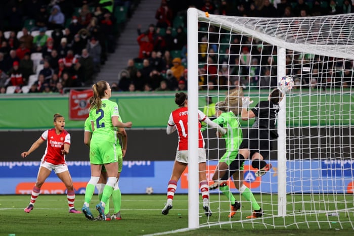 Wolfsburg keeper claws a header onto the post.