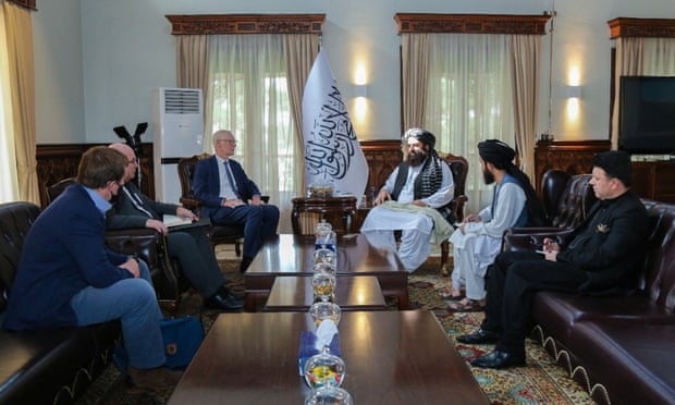 Britain’s high representative for Afghan transition, Sir Simon Gass, third from left, meets the Taliban’s acting foreign minister, Amir Khan Muttaqi