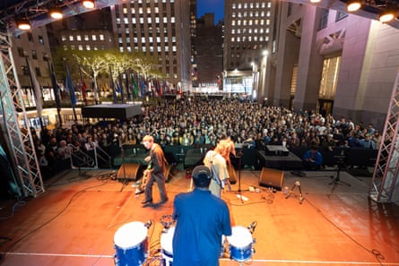 Behind view of an indie rock band playing to a packed crowd