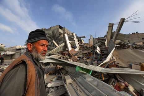 A Palestinian man inspects the damage at the site of Israeli strikes on houses in Khan Younis