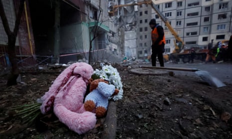 Tributes are left at the site where an apartment block was heavily damaged by a Russian missile strike in Dnipro