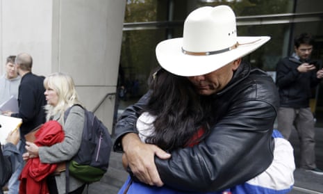 Defendant Shawna Cox speaks at left as supporters hug outside federal court in Portland, Oregon, on Thursday.