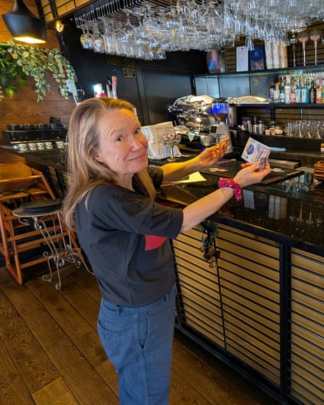 Jane Hoskyn paying cash at a bar counter