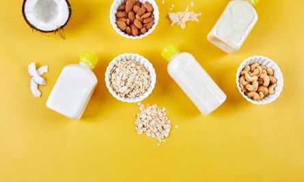bottles of milk next to oats, coconut, cashews and other foods