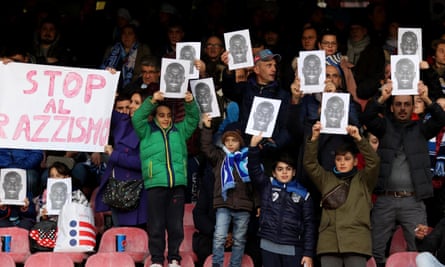 Fans hold up photos of Koulibaly and an anti-racism banner