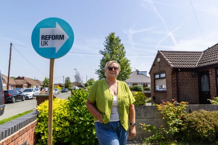 Stephanie Doohan next to a Reform sign outside her house