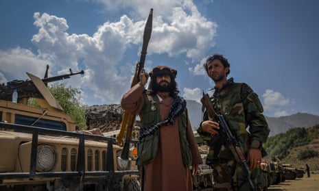 Afghan men supporting the security forces against the Taliban stand with their weapons in Bazarak, Panjshir province.