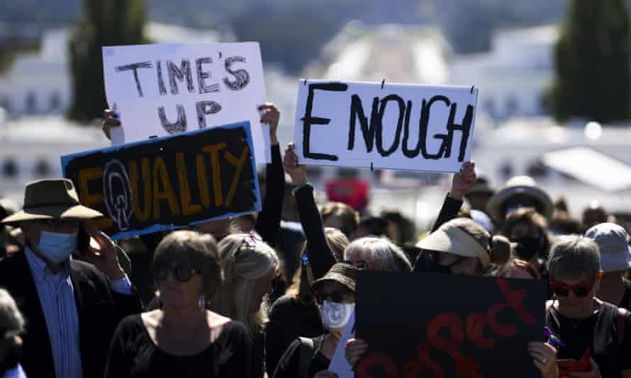Protesters hold up signs during the Women’s March 4 Justice in Canberra, March 15, 2021.