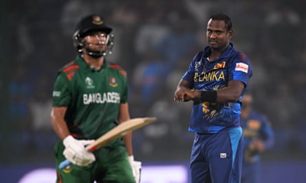 Time’s up: Angelo Matthews points to his wrist after dismissing Shakib Al Hasan.