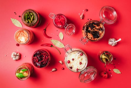 Probiotics, including Korean carrot, kimchi, beetroot, sauerkraut and pickled cucumbers, in glass jars.