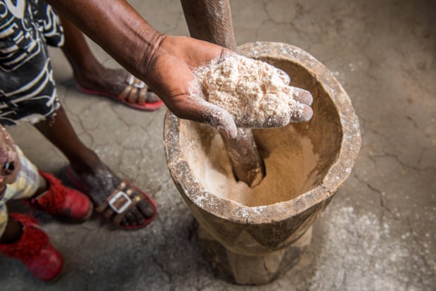 A woman shows sorghum flour in Sexaxa village in Botswana, Africa.