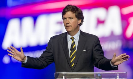 Tucker Carlson gesturing from behind a lectern