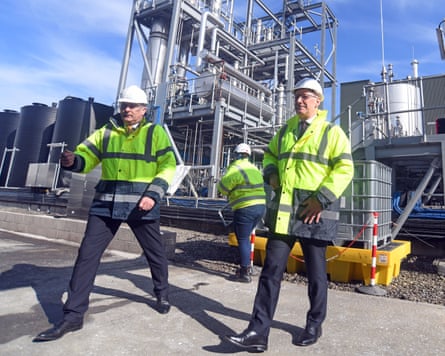John Swinney with Mark Simmers, both wearing yellow hi-vis jackets and white safety helmets