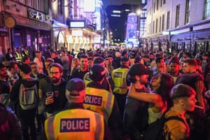 Police officers are seen walking through heavy crowds in Soho. The UK Government announced that Pubs, Hotels and Restaurants can open from Saturday, July 4th providing they follow guidelines on social distancing and sanitising