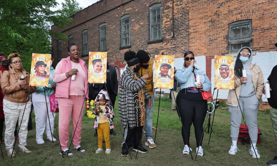 People participate in a vigil to honor the 10 people killed in a racist shooting at Tops market, on 17 May in Buffalo, New York. 