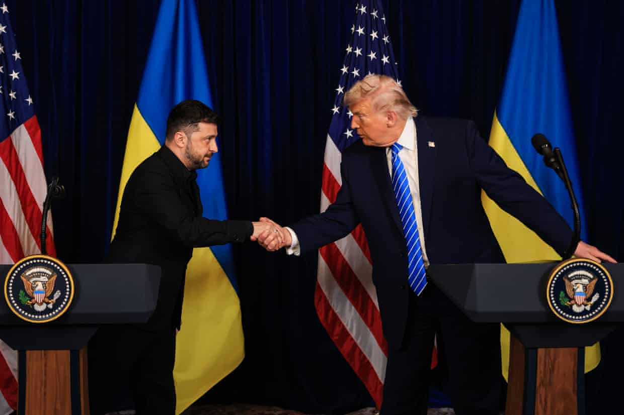 Two men in suits shake hands