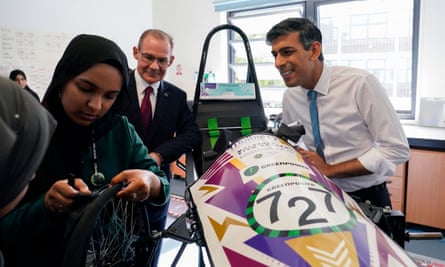 Rishi Sunak looks at a car prototype and meets students at Mulberry School for Girls in east London.