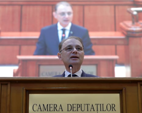 Romania's PM-designate Niculescu speaks at a lectern during a parliamentary confidence vote session