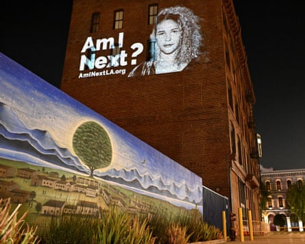 projection of face on a building with words ‘am I next?’