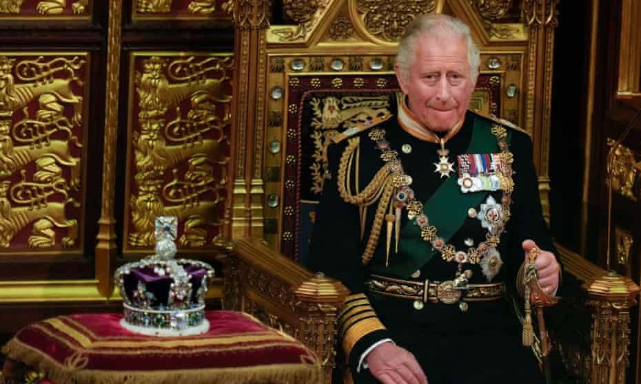 Prince Charles sat next to crown biting lip.