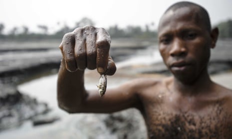 A fisherman displays his meagre catch from a creek near Goi in Ogoniland, Nigeria