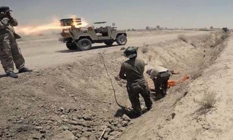 In this Tuesday, July 7, 2015 photo Iraqi security forces and allied Shiite militiamen launch rockets against Islamic State extremist positions in Saqlawiyah near Fallujah, Iraq. 
