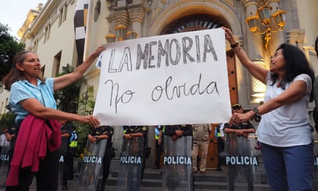 Protesters hold a banner saying ‘Memory Does Not Forget’ in front of the municipality of Miraflores district, in Lima, after the recent closure of the Place of Memory, Tolerance and Social Inclusion (Lum).