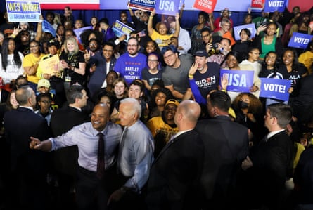 Joe Biden and Wes Moore stand among a crowd of supporters.