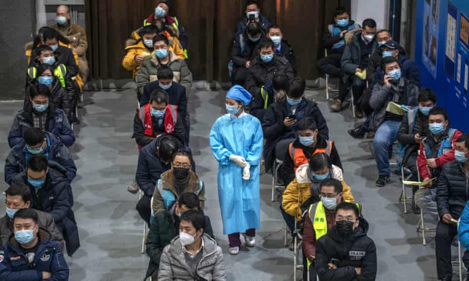 Chinese workers waiting for a jab at a mass vaccination centre for Chaoyang district in Beijing.