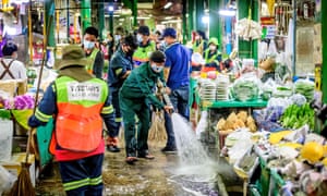 Employees of the Bangkok Metropolitan Authority clean and disinfect the Yodpiman Flower Market in Bangkok on 6 January 2021, after the government imposed further restrictions due to the recent Covid-19 coronavirus outbreak.