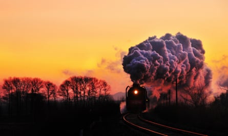 A steam locomotive travels on the railway at sunset in Linxi county, Chifeng city, north Chinas Inner Mongolia