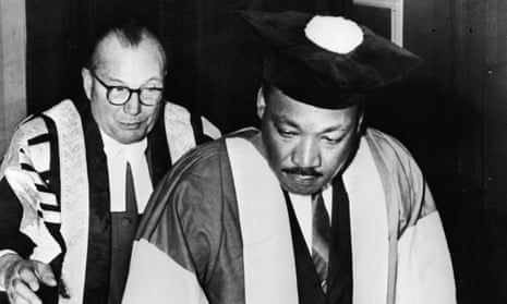 Dr. Martin Luther King, Jr., watched by Dr. Charles Bousenquet, signs the Degree Roll At Newcastle University after receiving an honorary Doctor of Civil Law degree, November 14, 1967. 
