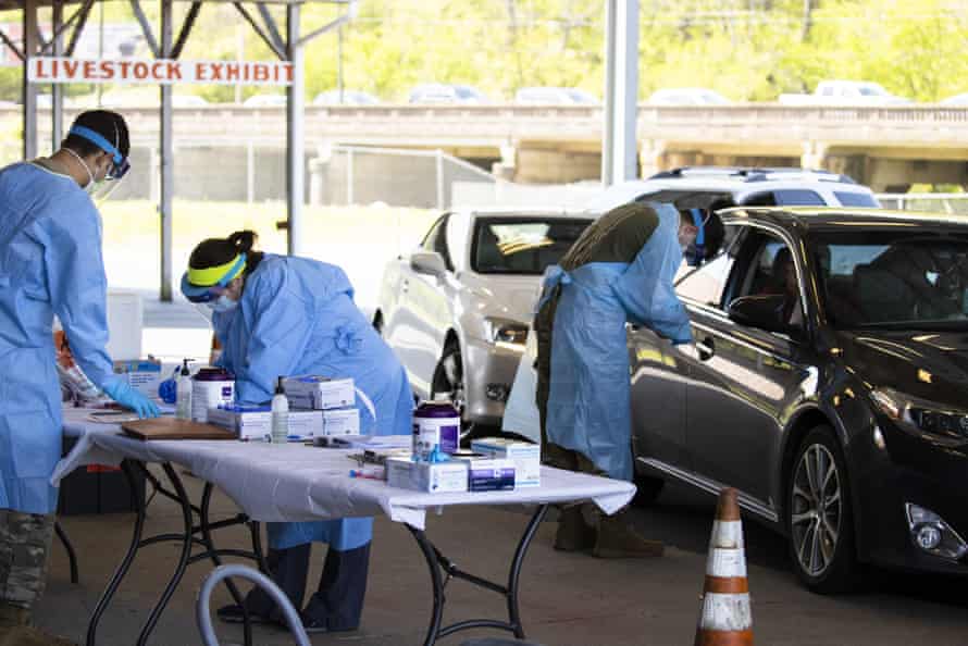 Medical personnel work a drive through coronavirus testing site on 18 April in Springfield, Tennessee.