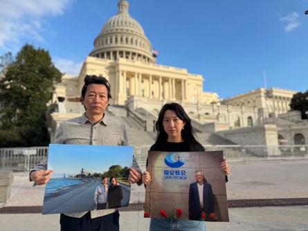 Gao Pu and Grace Jin Drexel stand in front of the US Capitol holding large pictures showing their fathers