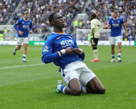 Thierno Barry slides on his knees celebrating a goal, arms crossed near his chest