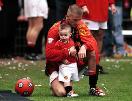 Baby love … David with Brooklyn after the Manchester United v Derby County match at Old Trafford