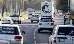 Portraits of Qatar’s Emir Sheikh Tamim bin Hamad Al-Thani on the back of vehicles and text reading in Arabic: ‘Tamim the glorious’ in Doha amid the diplomatic crisis.