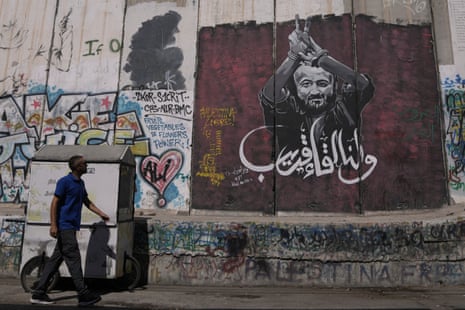A man walks past a mural depicting the Palestinian leader Marwan Barghouti, with a message that reads in Arabic, “See you soon”, on Israel’s separation barrier in the West Bank city of Bethlehem, Wednesday, Aug. 20, 2025.