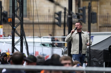 Robinson speaking on stage during the rally.