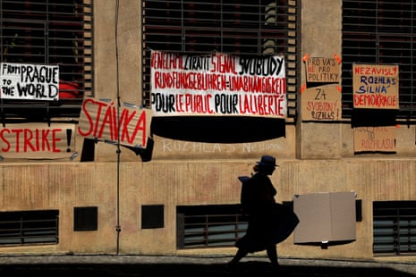 A woman walks past placards hanging on a building of Czech Radio as employees of public broadcasters strike in protest of the government's planned overhaul of public media funding, in Prague, Czech Republic.