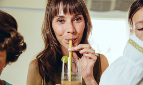Woman drinking a smoothie through a straw