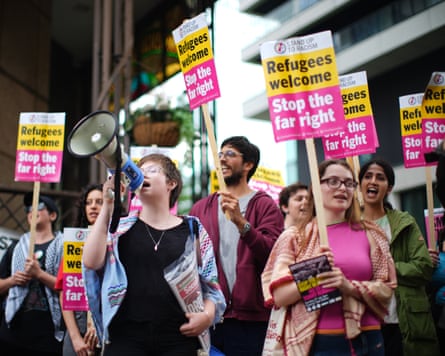 demonstrators with placards saying Refugees welcome, stop the far right