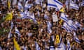 Protesters waving flags and carry banners gather in Tel Aviv