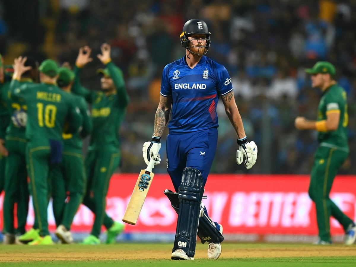 England's Ben Stokes walks away as South African players celebrate in the background.